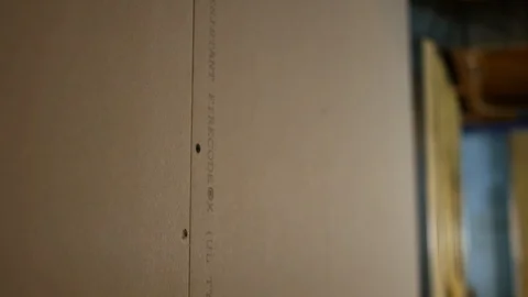 Camera pans down mold resistant drywall in unfinished basement  Stock Footage 95480171