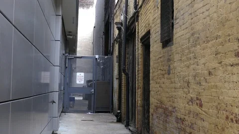 Camera pans down to reveal an rear of a building - backdoor entrance Stock Footage 85108556