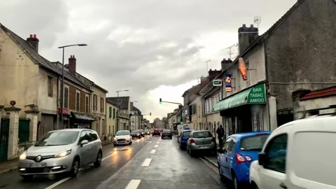 Camera pans forward with raindrops falling on the car window. Across the Stock Footage 245328495