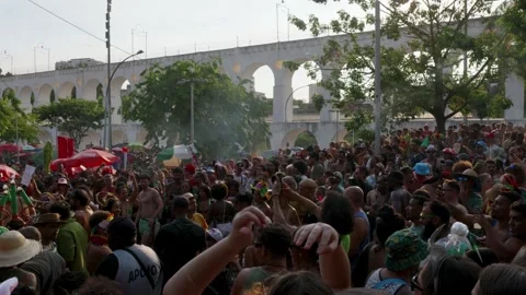 Camera pans left across a crowded Rio Carnaval bloco near Arcos da Lapa in Stock Footage 336295853