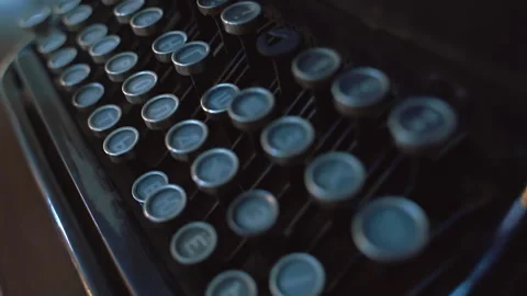 Camera pans from left to right across typewriter keys moving in slow motion. Stock Footage 219644884