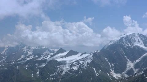 Camera Pans From Left To Right Across A Majestic Mountain Range With Snow-Capped Video stock 310739325