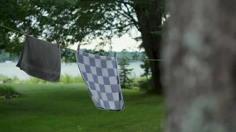 Camera Pans Left to Towels Waving on a Heavy Wind at a Lakehouse (slow motion) Vídeos de archivo 315078543
