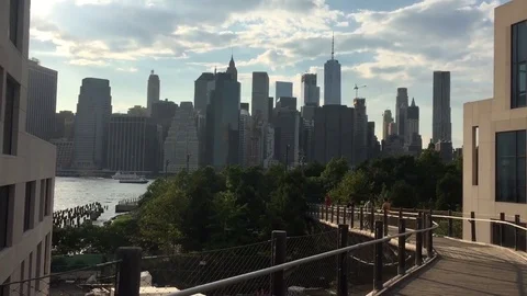 Camera pans to lower Manhattan NYC skyline from Brooklyn Stock Footage 78505658