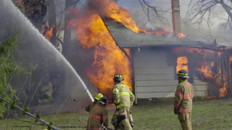 Camera pans over burning house Stock Footage 61179607