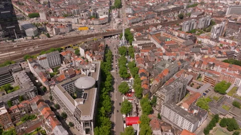 Camera pans over the city of Brussels, showing colorful buildings and train Stock Footage 302183804