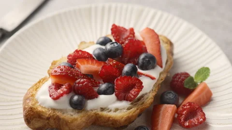 The camera pans over a croissant filled with berries Stock Footage 149731012