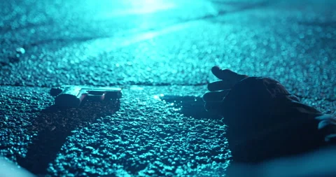 Camera Pans Over Dead Hand Next To Pool of Blood on Concrete. Gun on Concrete Stock Footage 272177117