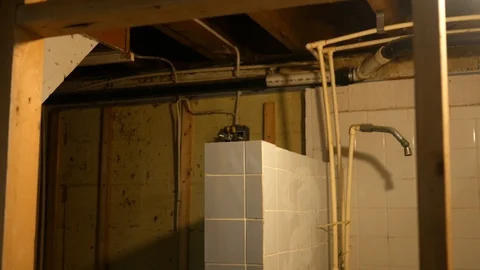 Camera pans over a demolished basement bathroom in the early state of remodel Stock Footage 93532750