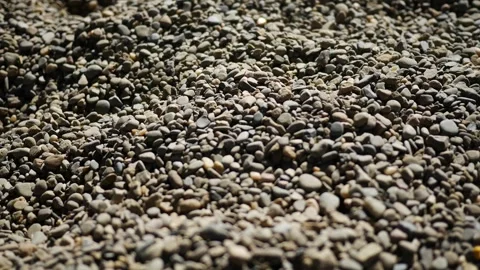 Camera Pans Over Gray Rocky Pebbles or River Rock Stock Footage 347033950