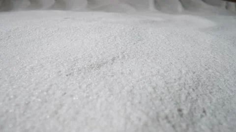 Camera pans over a mound of dry white sand. Close up shot of a sandy dune with Stock Footage 169838925