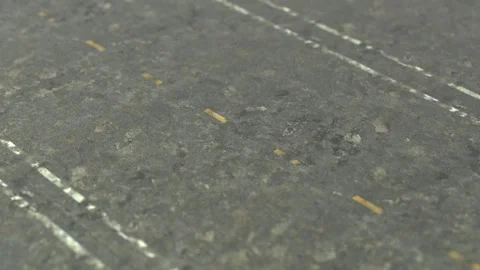The camera pans over the need to update the lane markings on the concrete Stock Footage 148383601