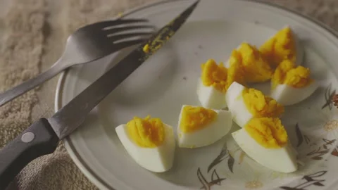 Camera pans over a plate with a boiled egg and toast bred Stock Footage 136655265