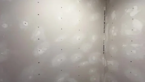 Camera pans over unpainted drywall in remodeled closet - 2 Stock Footage 303350500