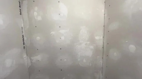 Camera pans over unpainted drywall in remodeled closet - 1 Stock Footage 303350501