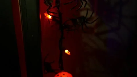 Camera pans up pumpkin and spider string lights at underground Halloween party-  Stock Footage 142321463