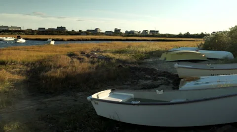 Camera Pans Right To Left, Over A Boats On Marshland, And Beautiful Harbor Stock-Footage 61172955