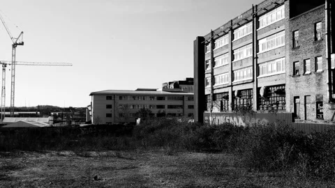 Camera pans to the right to reveal an old factory building Stock Footage 171800201