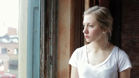 Camera Pans Right To Reveal Sad Young Woman Looking Out Window Stock Footage 36110787