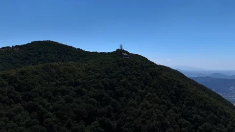 Camera pans right to show the tibidabo amusement park on a mountain top Stock Footage 285260989