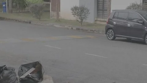 The camera pans from the roadside curb; it is raining. Stock Footage 345470326