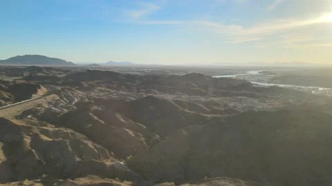 Camera Pans From Rugged Desert Terrain Towards Distant River Vídeo Stock 209303086