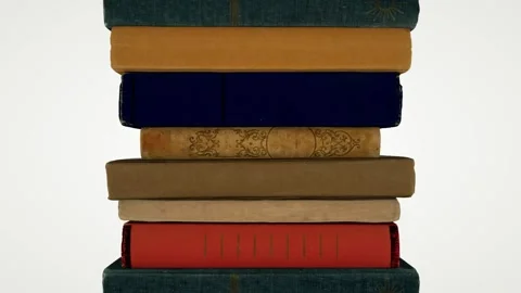 The camera pans up to show a stack of old books. Seamless loop. Stock Footage 155179230