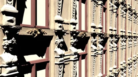 The camera pans from the side and bottom up to the facade of the building with Stock Footage 155179220