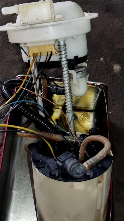 Camera pans slowly over disassembled car fuel pump module wires Stock Footage 335834659