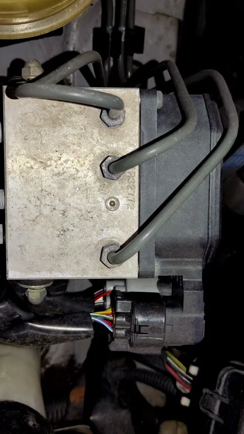 Camera pans slowly over a dusty car ABS modulator block Stock Footage 335835090