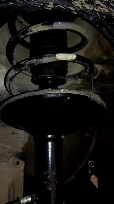 Camera pans slowly over a installed car coil spring suspension Stock Footage 335834694