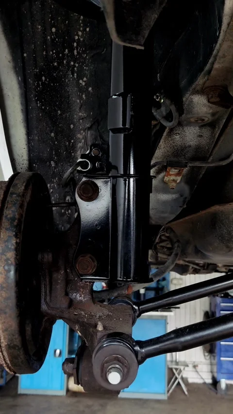 Camera pans slowly over a newly installed car suspension assembly Stock Footage 335834489