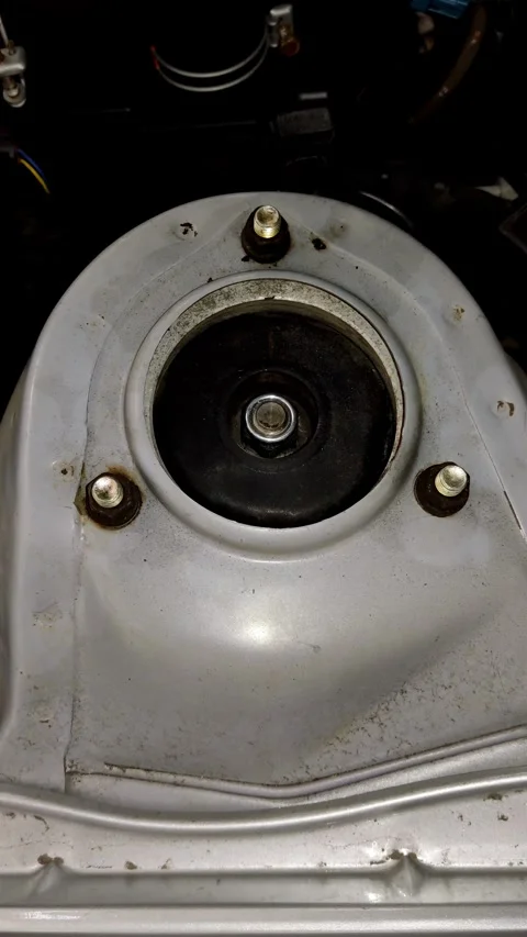 Camera pans slowly over a newly installed car strut mount Stock Footage 335835111