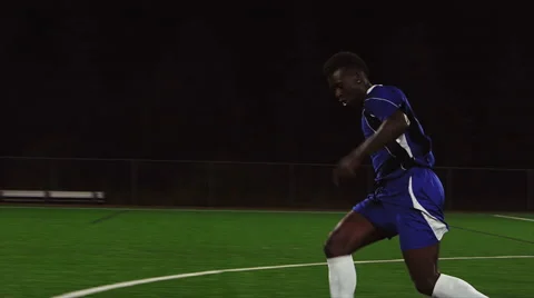 The camera pans with a soccer player as he scores a goal Video stock 56227467