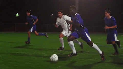 The camera pans with a soccer team as they score a goal Stock Footage 56226967