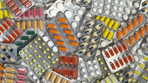 Camera pans a top view of the tablet. Many colored pills. Stock Footage 73031386