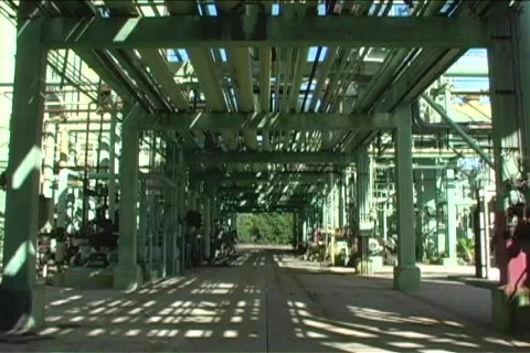 The camera pans the underneath of a large construction made of green pipes. Stock Footage 439371