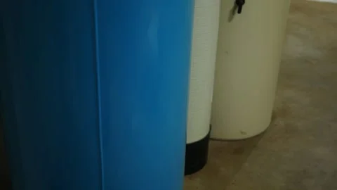 Camera Pans up Water Filtration System Tanks in Residential Home Stock Footage 332576180