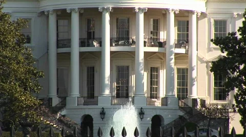 The camera pans-up the White House to the large flag-pole of the roof Video stock 439730