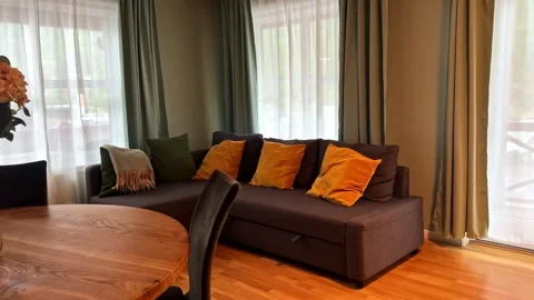 Camera Passes Over Table With Flowers Revealing Cozy Sofa In Living Room Stock Footage 340857808