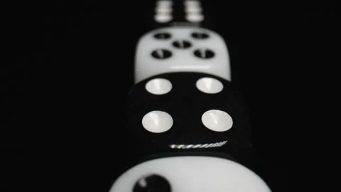 The Camera Passes Over the Top of the White and Black Dice. Count to Six. Macro Stock Footage 186935743