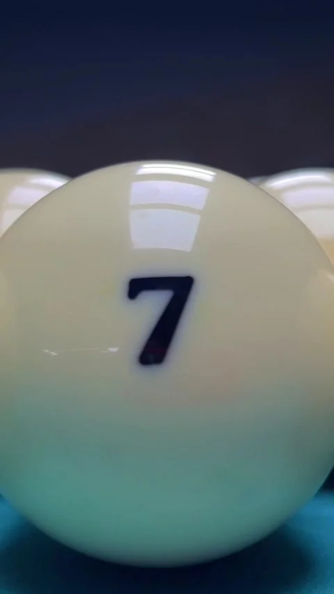 Camera passes by row white balls with numbers 6, 7, 2, 1, 3 on green pool table Stock Footage 278336565