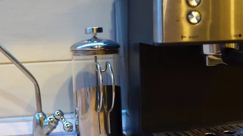 The camera passes through a coffee pot, coffee maker, coffee grinder, mug and ke Stock Footage 104369253