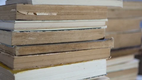 Camera passing near stack of old books Stock Footage 113100077