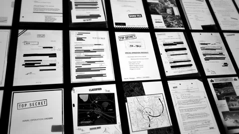 Camera passing over top secret classified looking documents on black background Vídeo Stock 312568774
