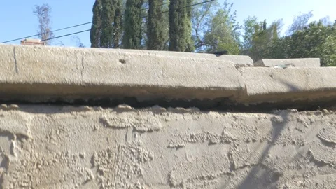 Camera peaking out from rock ruins Stock Footage 127099355
