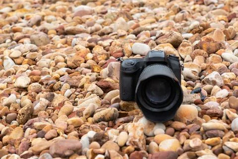 Camera On Pebble Beach Stock Photos