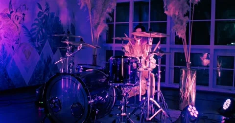 Camera peeks out from the corner and getting closer to the girl playing drums Stock Footage 196895341