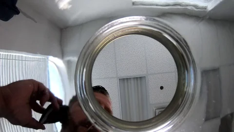 Camera is placed inside the jar as the man puts US dollar banknote to it Stock Footage 108116069