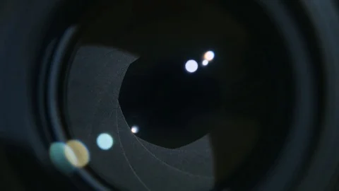 Camera prime lens. Close Up of closing camera aperture with lights Stock Footage 84037362